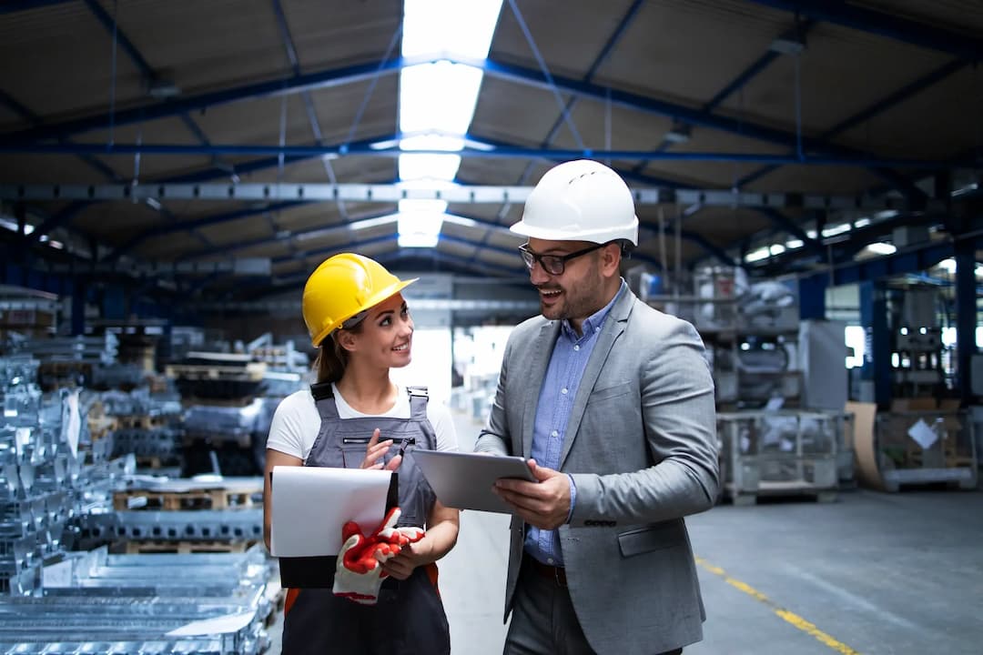Engineers discussing plans in a manufacturing plant